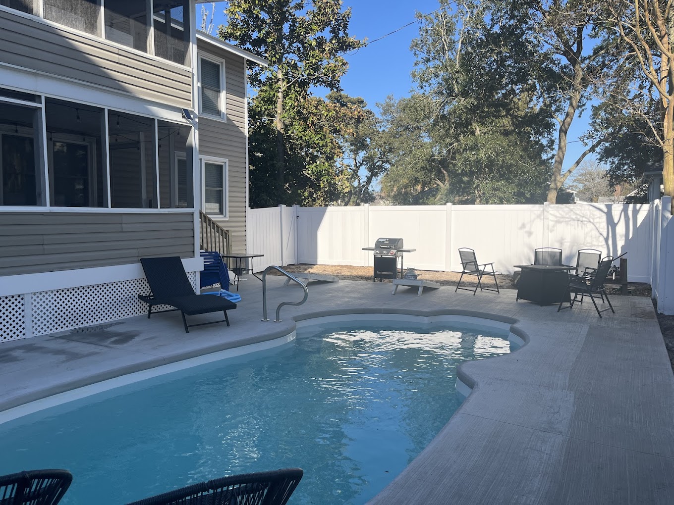 Beautiful aluminum fence around swimming pool in residential backyard
